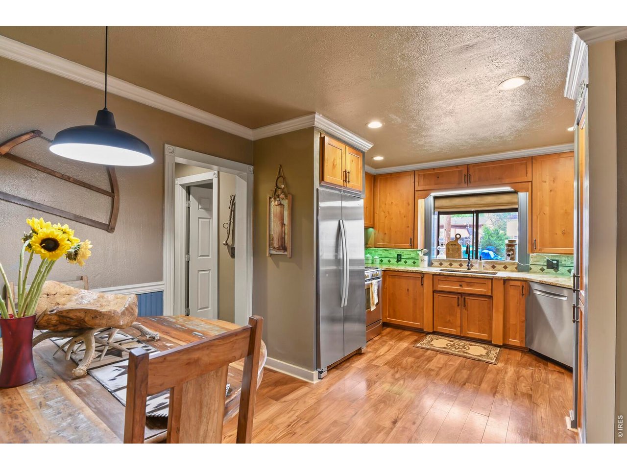 417 2nd Street Fort Lupton, CO 80621 - Photo 7 of 24 a open kitchen with stainless steel appliances granite countertop a stove and a refrigerator