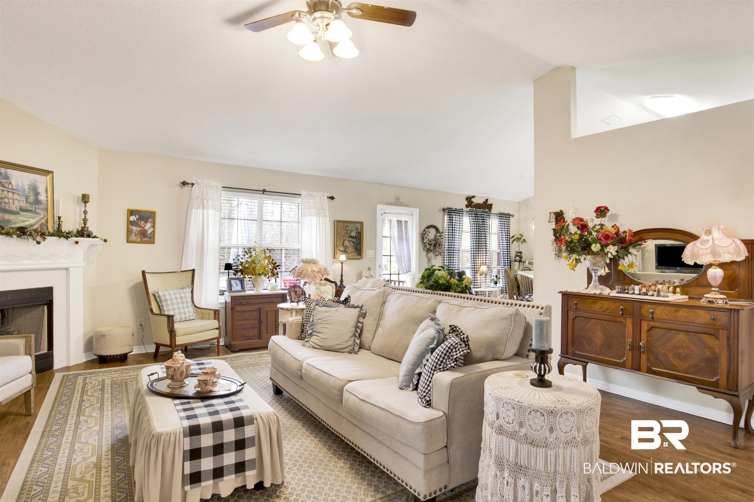 11697 Balsam Court Daphne, AL 36527 - Photo 10 of 31 Living room with vaulted ceiling, dark hardwood / wood-style floors, and ceiling fan