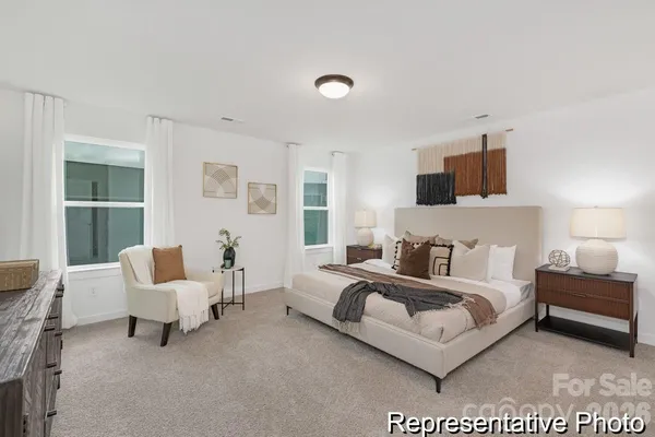 a spacious bedroom with a bed and a couch