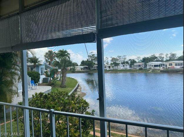 398 Leopard Lane, Unit 398 Naples, FL 34114 - Photo 11 of 50 a view of a lake from a balcony