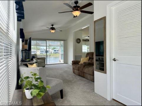 398 Leopard Lane, Unit 398 Naples, FL 34114 - Photo 13 of 50 a living room with furniture and a large window
