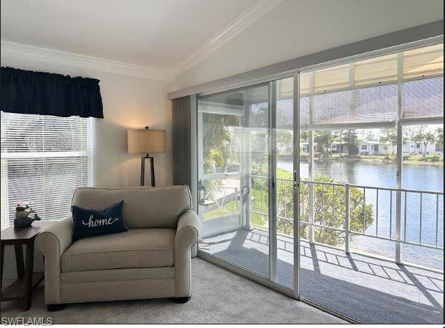398 Leopard Lane, Unit 398 Naples, FL 34114 - Photo 17 of 50 a living room with furniture and a floor to ceiling window