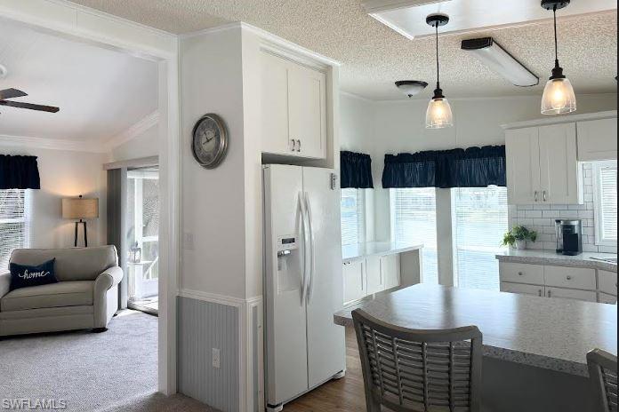 398 Leopard Lane, Unit 398 Naples, FL 34114 - Photo 23 of 50 a kitchen with stainless steel appliances granite countertop a refrigerator a sink dishwasher a stove and a dining table with wooden floor