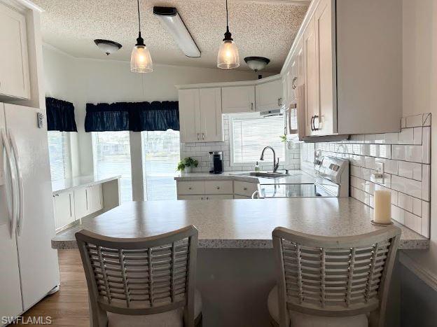 398 Leopard Lane, Unit 398 Naples, FL 34114 - Photo 24 of 50 a kitchen with stainless steel appliances granite countertop a sink a stove and a refrigerator