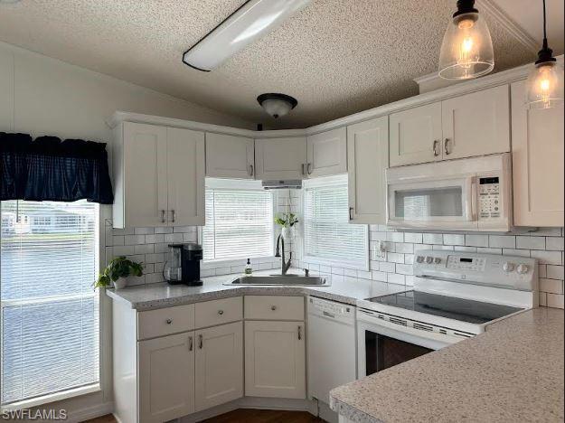 398 Leopard Lane, Unit 398 Naples, FL 34114 - Photo 25 of 50 a kitchen with stainless steel appliances granite countertop a sink stove and refrigerator
