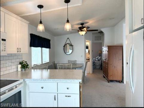 398 Leopard Lane, Unit 398 Naples, FL 34114 - Photo 26 of 50 a view of a kitchen with a sink stainless steel appliances and cabinets