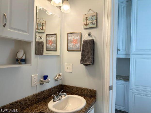 398 Leopard Lane, Unit 398 Naples, FL 34114 - Photo 29 of 50 a bathroom with a sink and a mirror