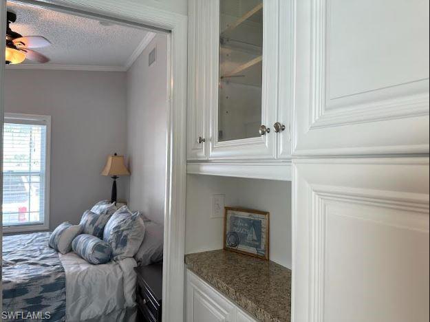 398 Leopard Lane, Unit 398 Naples, FL 34114 - Photo 31 of 50 a bedroom with a bed and a mirror