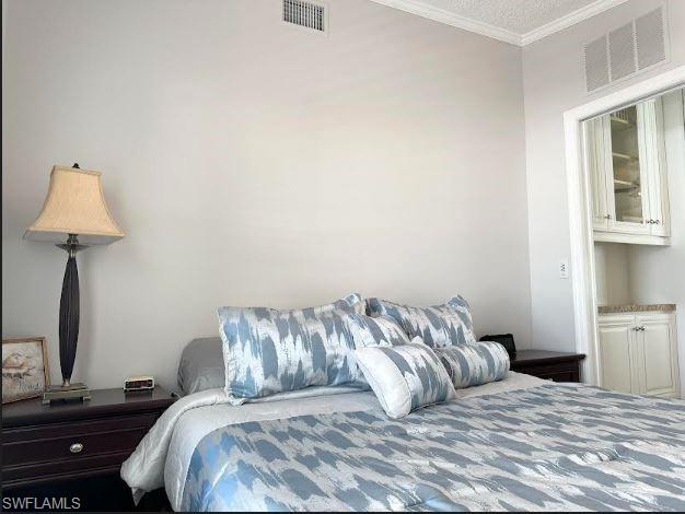 398 Leopard Lane, Unit 398 Naples, FL 34114 - Photo 32 of 50 a bedroom with a bed and a lamp