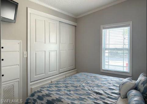 398 Leopard Lane, Unit 398 Naples, FL 34114 - Photo 33 of 50 a bedroom with a bed and a window