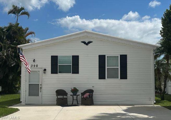 398 Leopard Lane, Unit 398 Naples, FL 34114 - Photo 40 of 50 a front view of a house with a garden