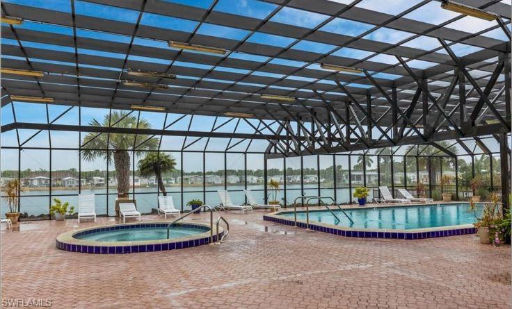 398 Leopard Lane, Unit 398 Naples, FL 34114 - Photo 46 of 50 a view of a room with a wooden floor and a garage
