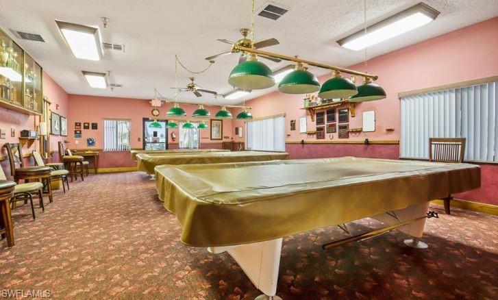 398 Leopard Lane, Unit 398 Naples, FL 34114 - Photo 49 of 50 a swimming pool with outdoor seating