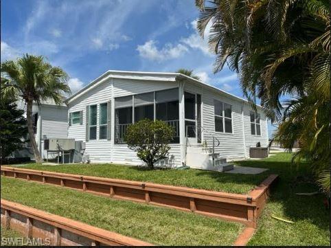 398 Leopard Lane, Unit 398 Naples, FL 34114 - Photo 5 of 50 a front view of a house with garden