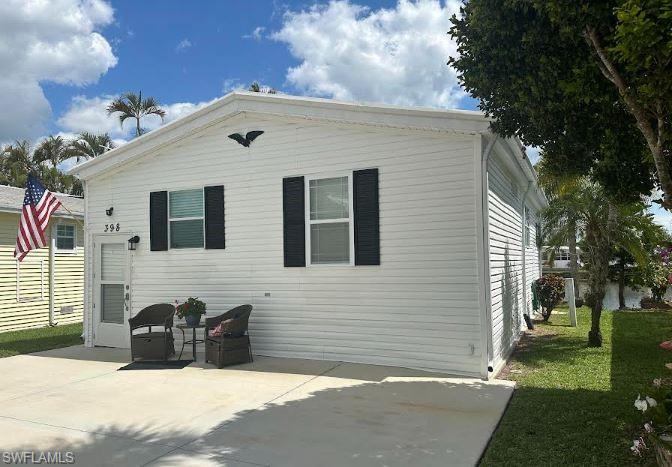 398 Leopard Lane, Unit 398 Naples, FL 34114 - Photo 7 of 50 a front view of a house with a yard