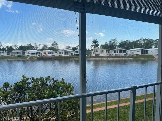 398 Leopard Lane, Unit 398 Naples, FL 34114 - Photo 10 of 50 a view of a lake with a mountain view