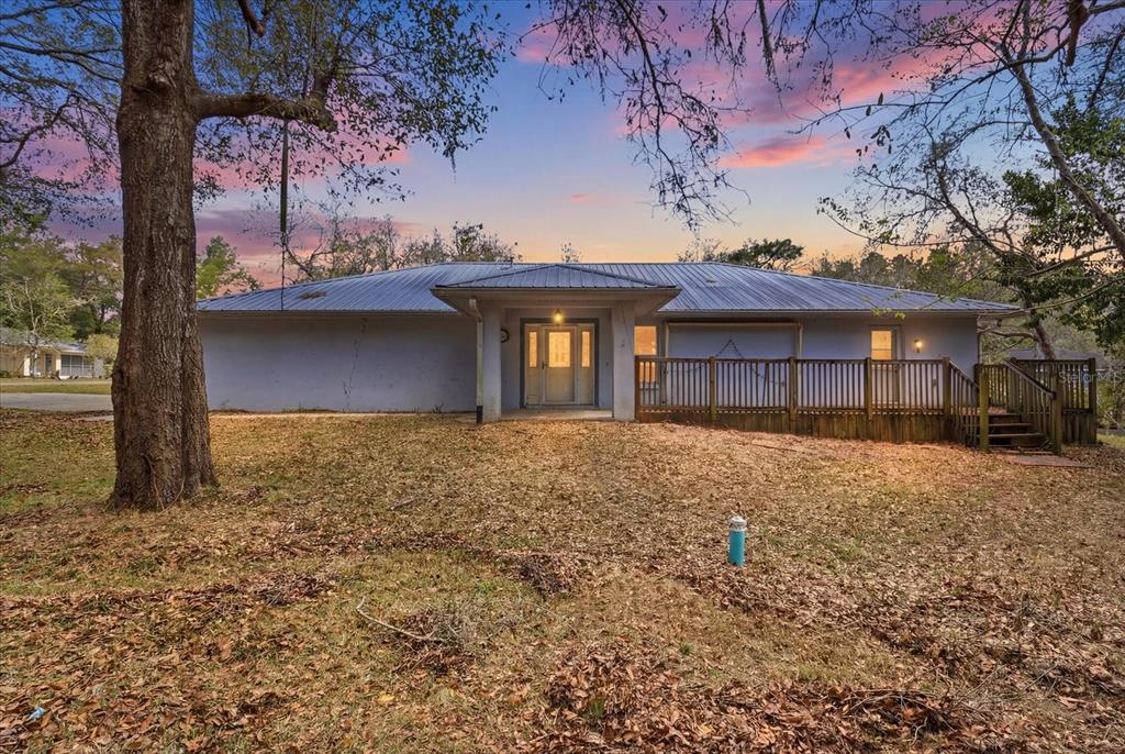 5120 East Hopp Lane Inverness, FL 34452 - Photo 1 of 26 a front view of a house with a yard and garage
