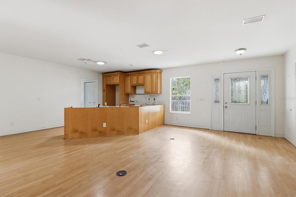 5120 East Hopp Lane Inverness, FL 34452 - Photo 13 of 26 an empty room with wooden floor and windows