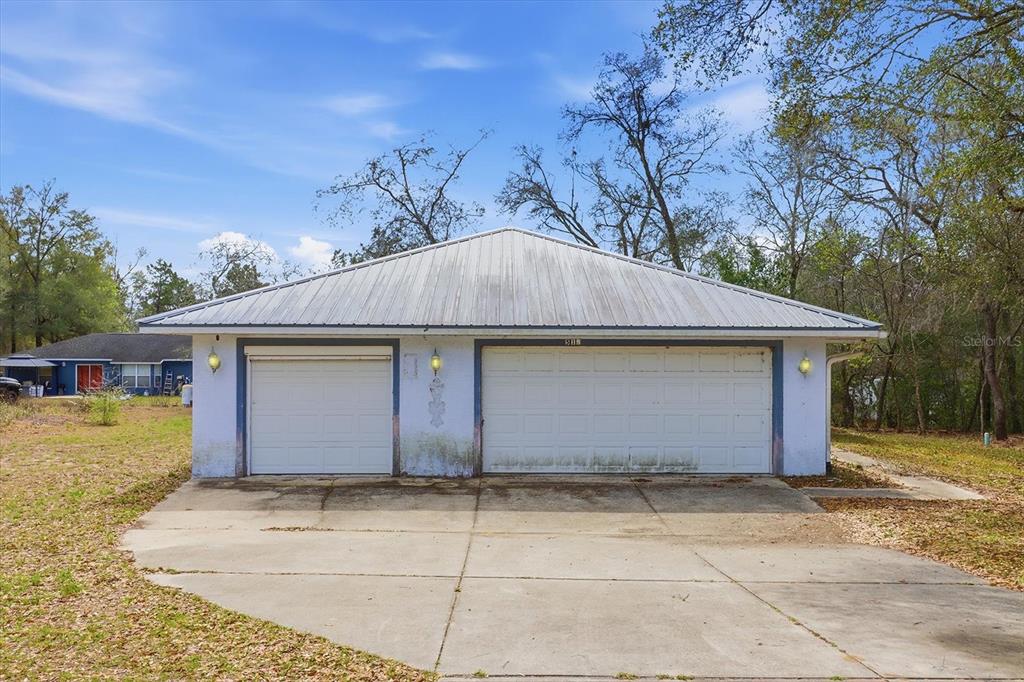 5120 East Hopp Lane Inverness, FL 34452 - Photo 4 of 26 a front view of a house with a yard and garage