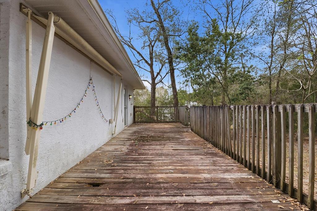 5120 East Hopp Lane Inverness, FL 34452 - Photo 8 of 26 a view of a pathway of a house with wooden fence