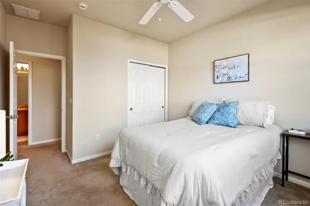 a bedroom with a bed and a mirror