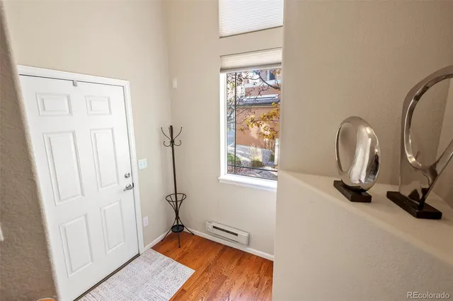 a view of a livingroom with a window and a bathroom