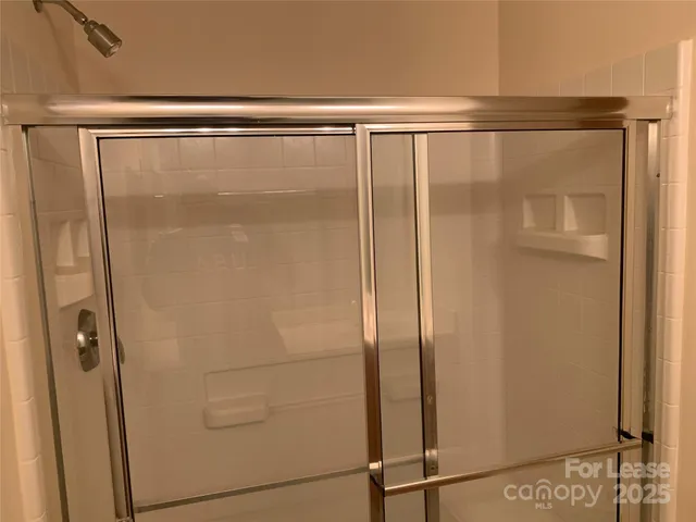 a bathroom with a glass shower door