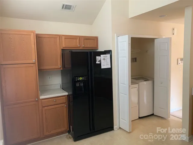 a room with a refrigerator and cabinets