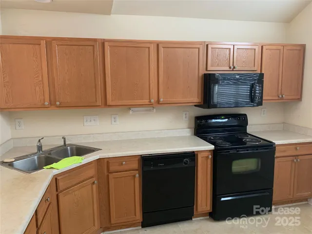 a kitchen with cabinets appliances and a sink