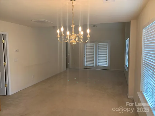 a view of a chandelier in hallway