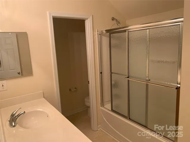 a bathroom with a shower and a sink