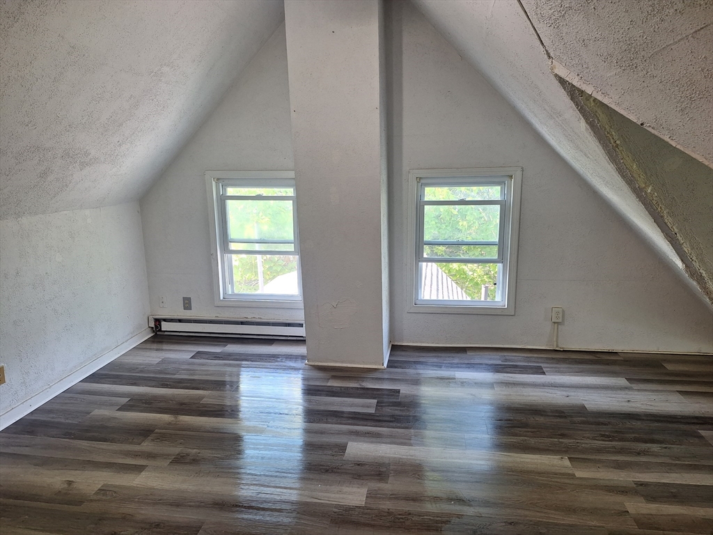 85 Lower E Street, Unit 2 Dedham, MA 02026 - Photo 3 of 13 a view of empty room with wooden floor and fan