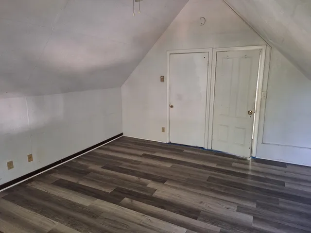 a view of room with wooden floor