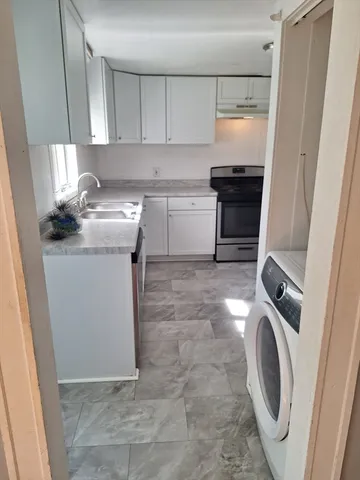 a kitchen with a sink a washer and dryer