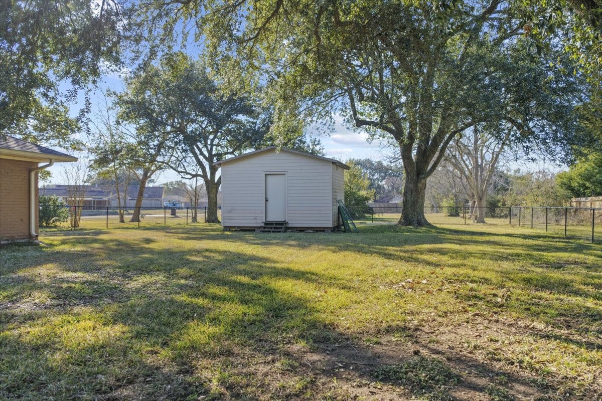 105 Alice Street Anahuac, TX 77514 - Photo 32 of 39 a view of a house with a yard
