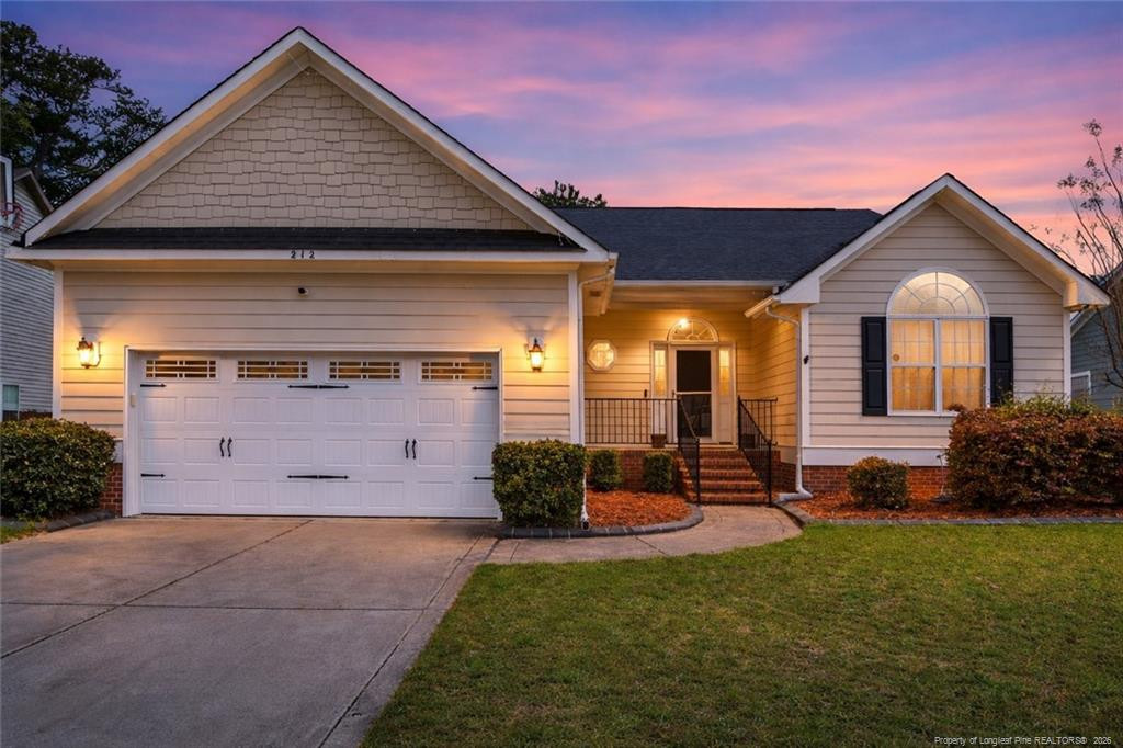 212 Lennox Loop Raeford, NC 28376 - Photo 2 of 47 a front view of a house with garden