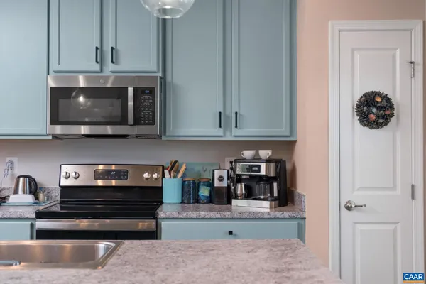 a kitchen with stainless steel appliances granite countertop a refrigerator and a stove top oven