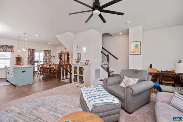 a living room with furniture and kitchen view
