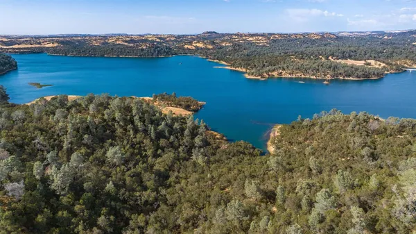 an aerial view of ocean with residential house and lake