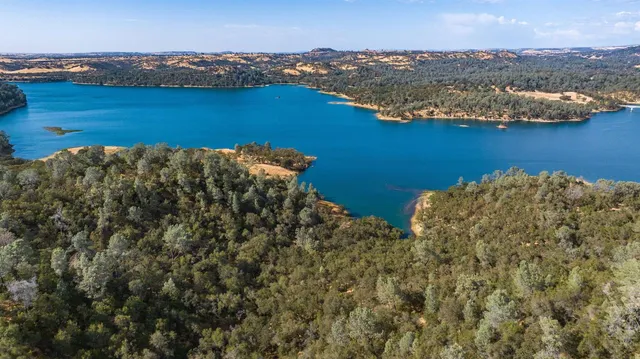 an aerial view of ocean with residential house and lake