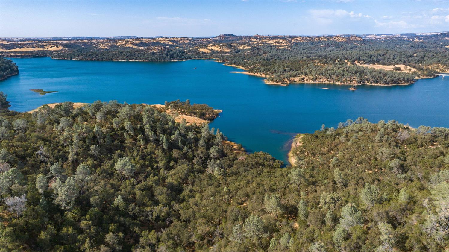 an aerial view of ocean with residential house and lake