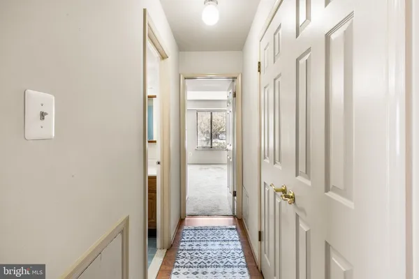 a view of a hallway with a white walls