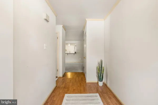 a view of hallway with wooden floor