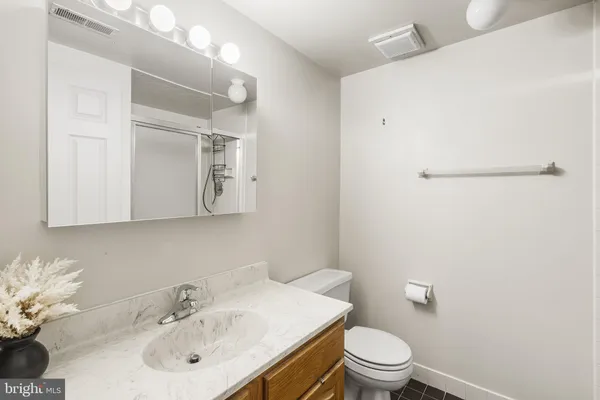 a bathroom with a sink toilet and mirror
