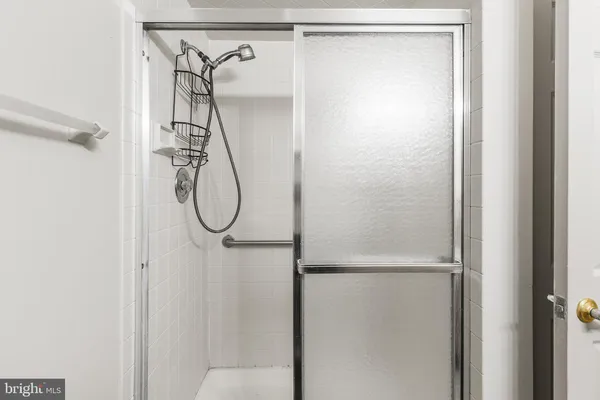 a bathroom with a glass shower door