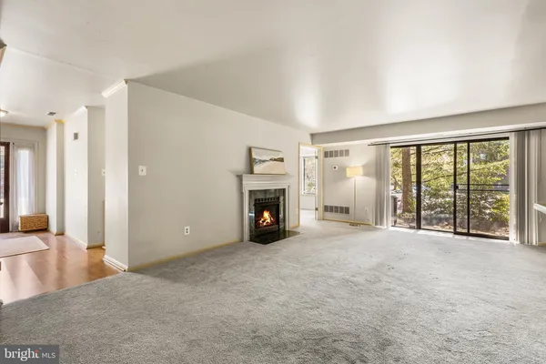 an empty room with furniture and a fireplace