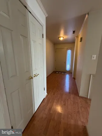 a view of hallway with wooden floor