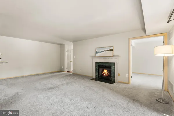 a view of an empty room with a fireplace