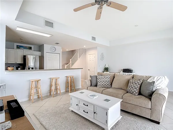 a bedroom with a bed a chandelier and a window