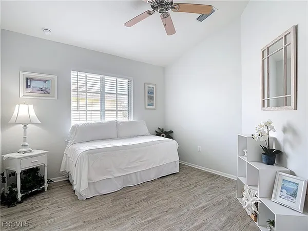 a bedroom with a bed a flat screen tv and dresser